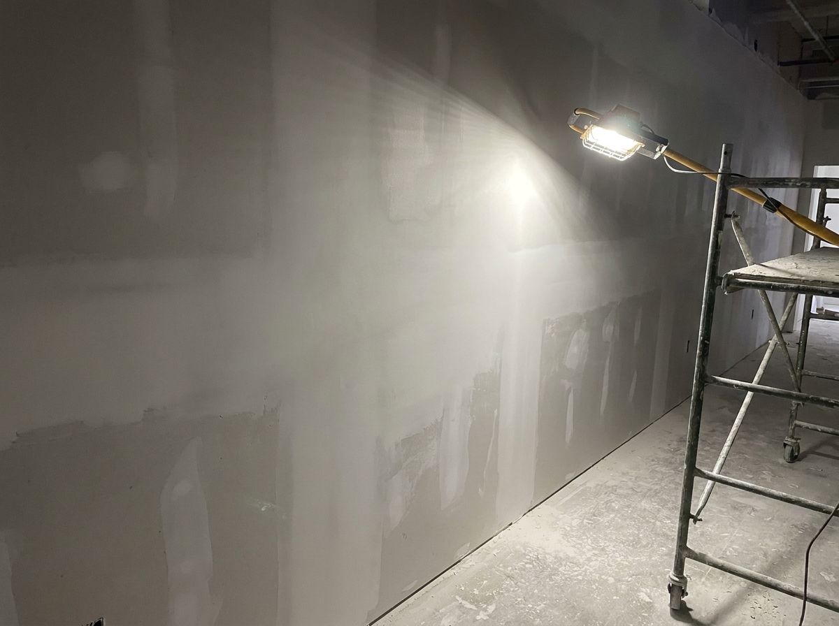 Skim-coated commercial wall sanded smooth and ready for paint