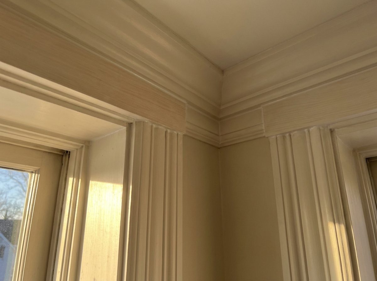 Crisp repaired crown molding and window casing detail in a higher-end New England home