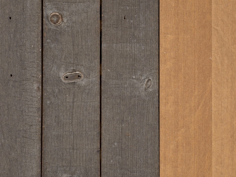 Close view of an old weathered gray deck board with checked cracked grain and a rusted nail head, beside it the edge of a fresh new mahogany replacement board, honest repair in progress