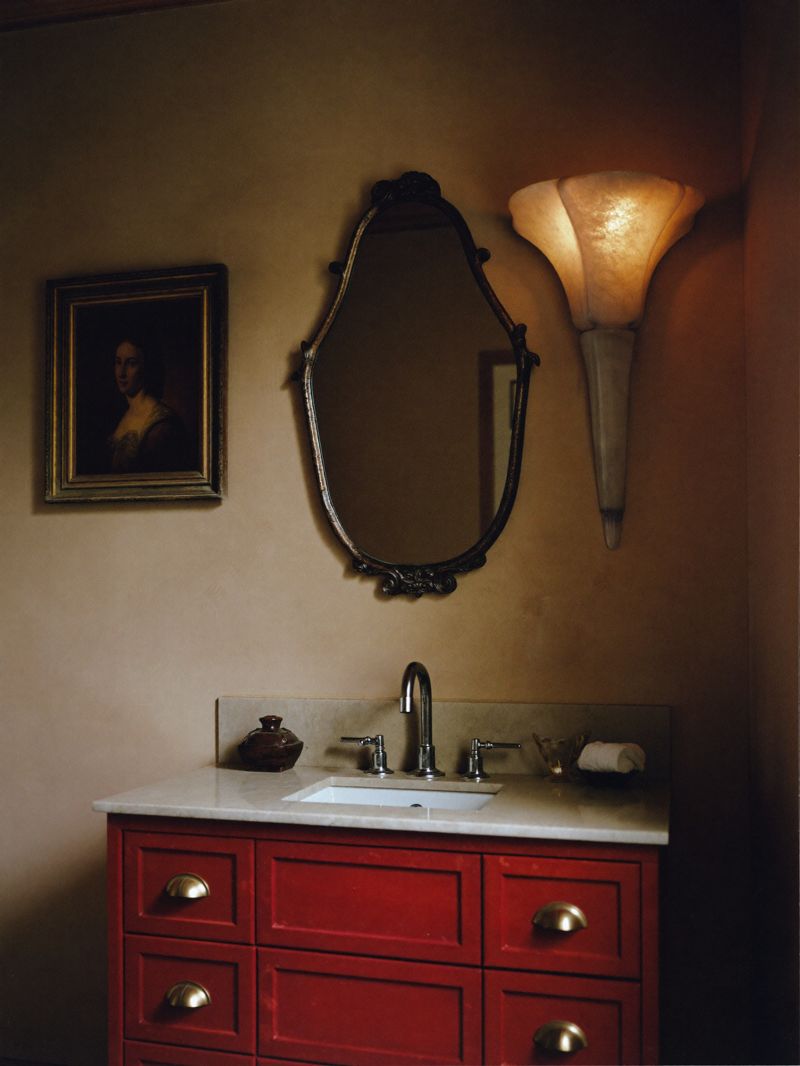 Oxblood lacquered vanity with antique mirror and alabaster sconce