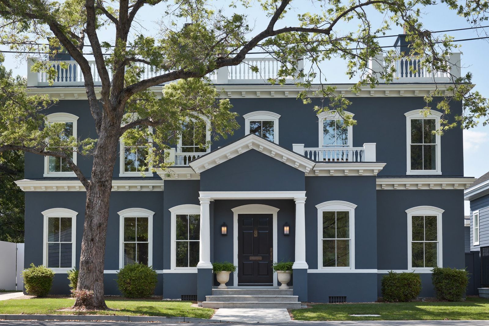 Repainted colonial exterior in deep blue with crisp white trim