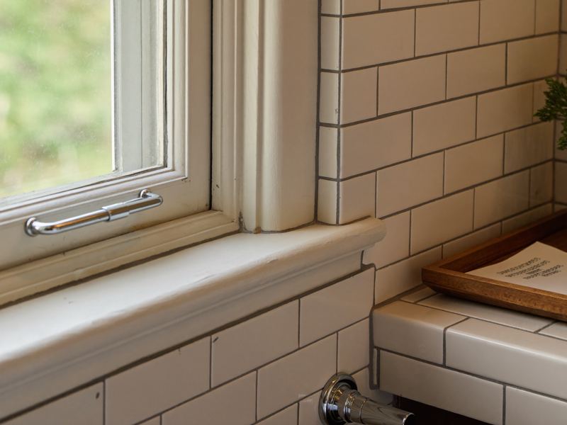 Subway tile shower bench and trimmed window detail