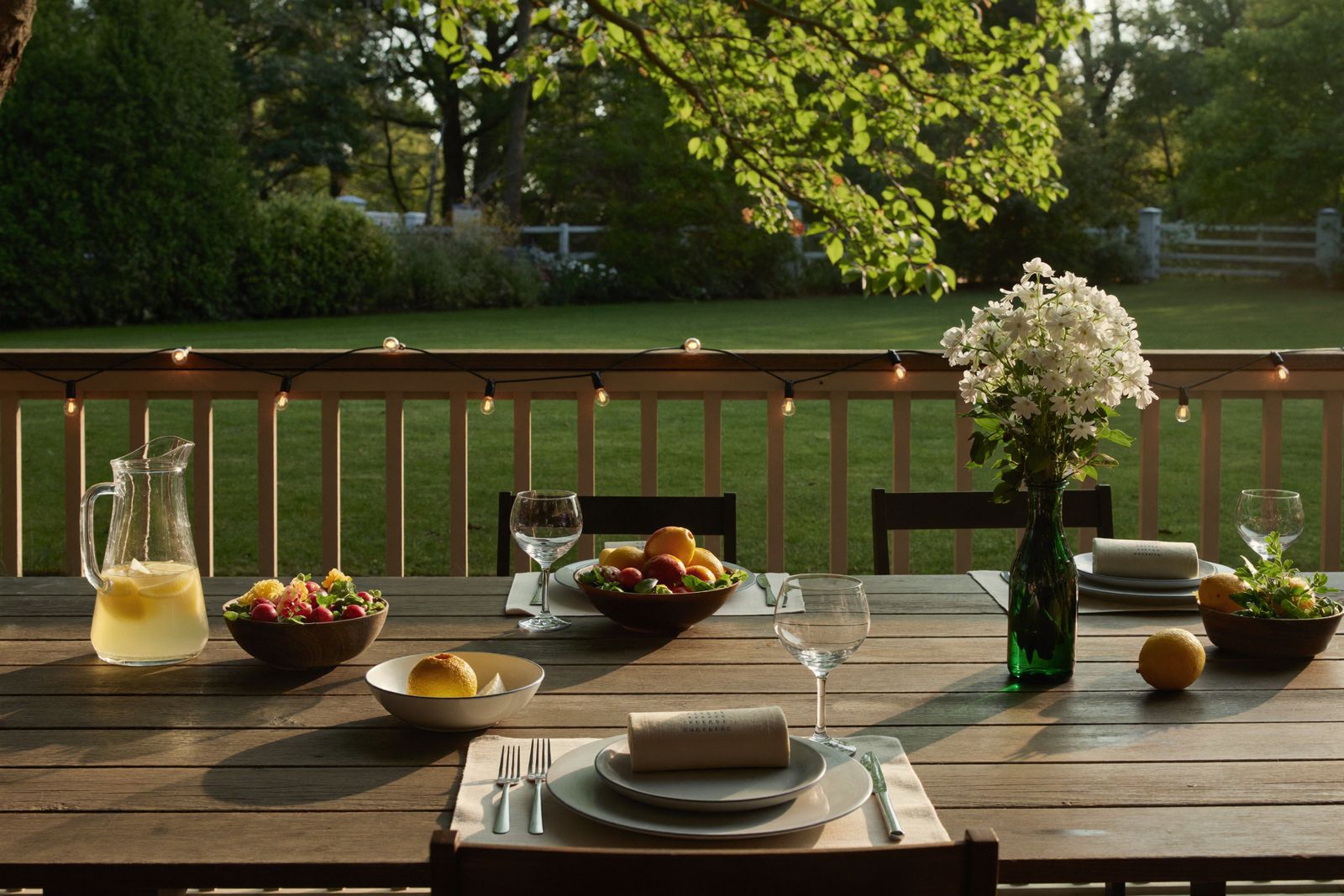 Summer evening table set on a backyard deck