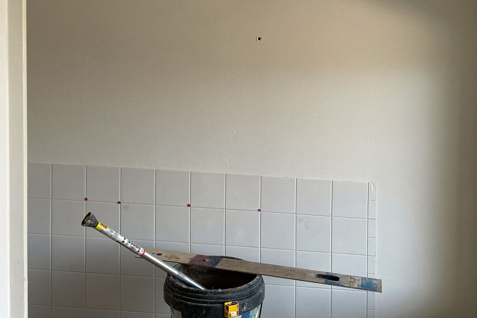Subway tile installation in progress with spacers