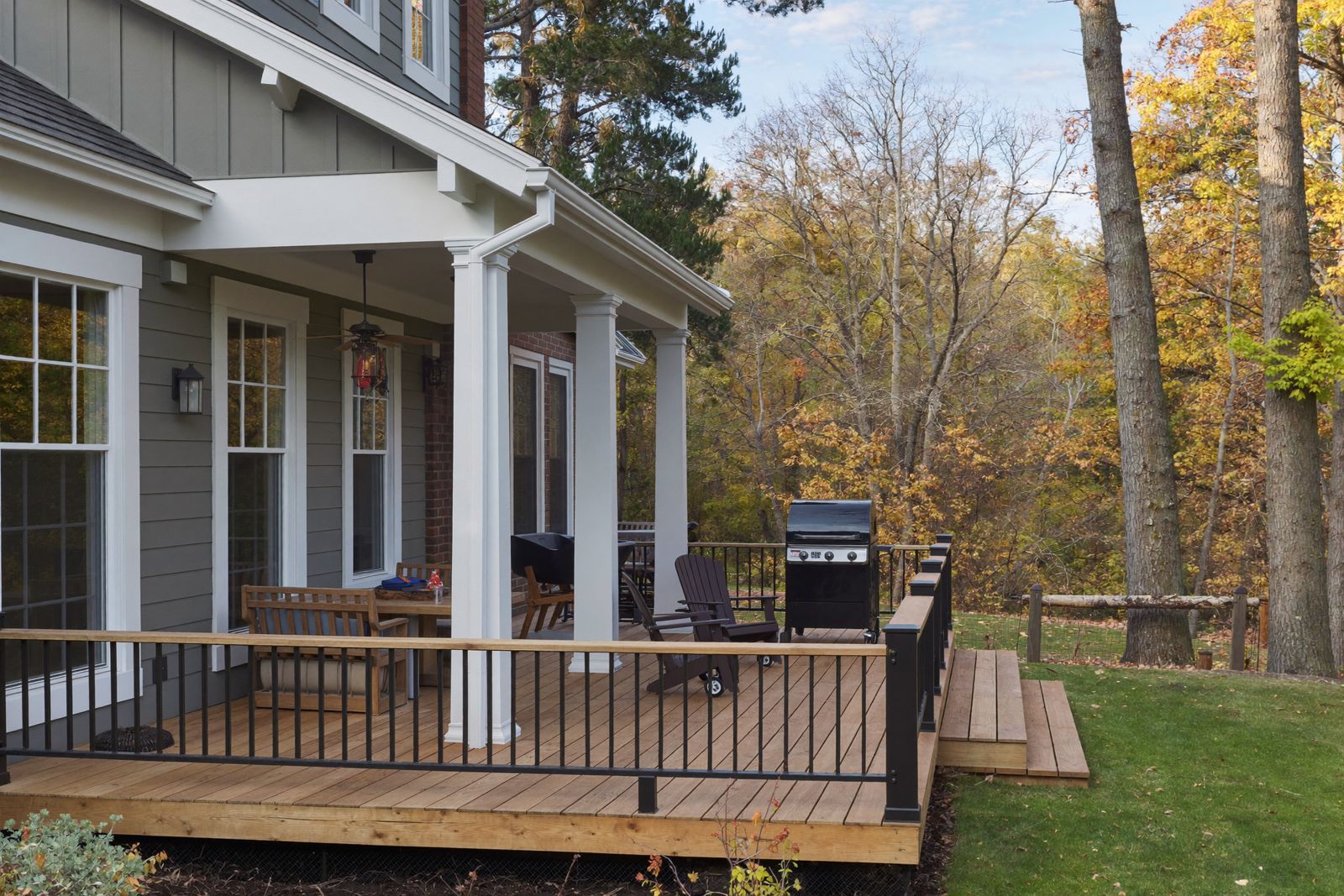 Backyard deck with composite decking on a Colonial home