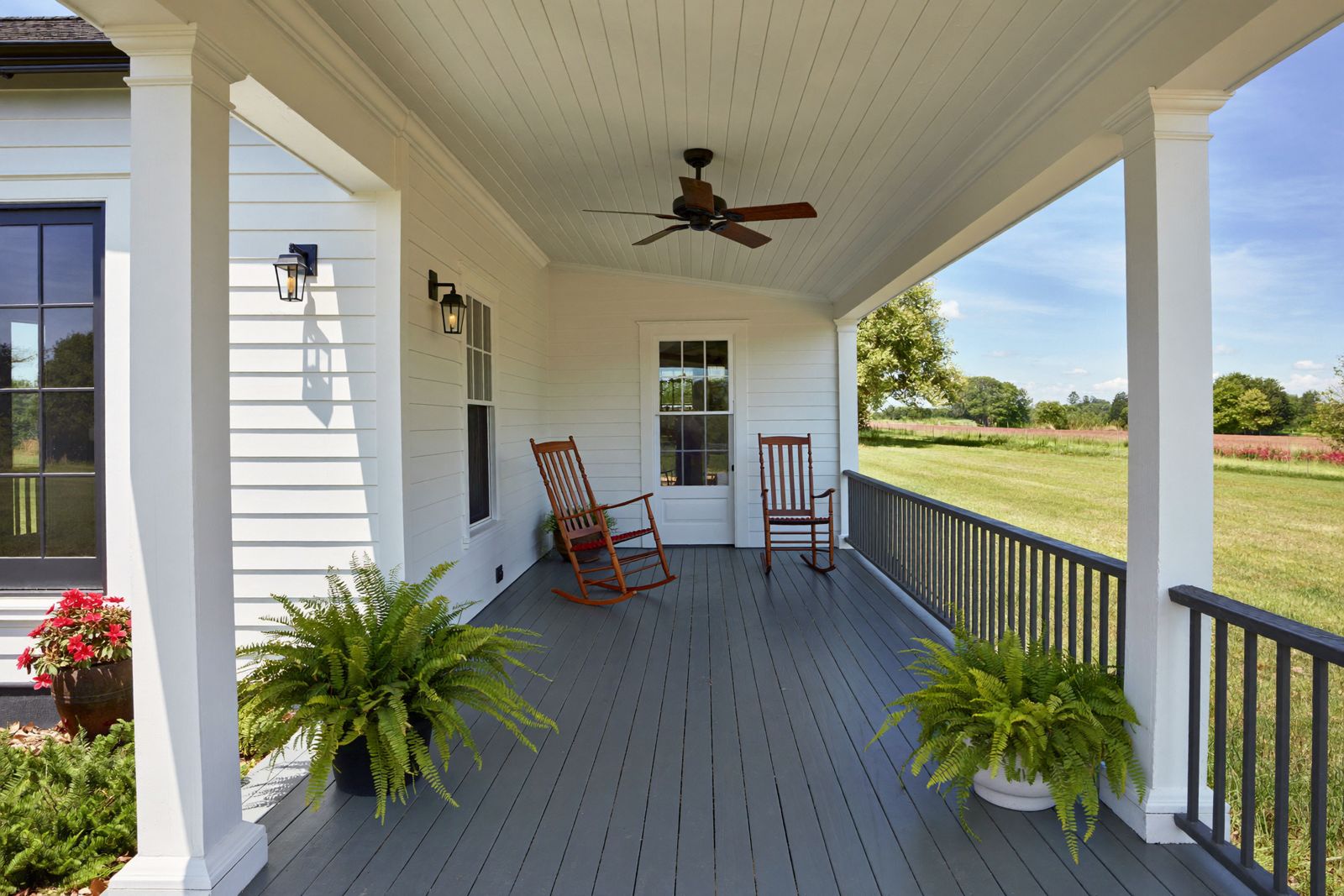 Farmer&rsquo;s porch with white posts and painted fir floor