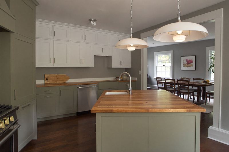 Renovated New England kitchen with painted cabinetry and warm wood floors