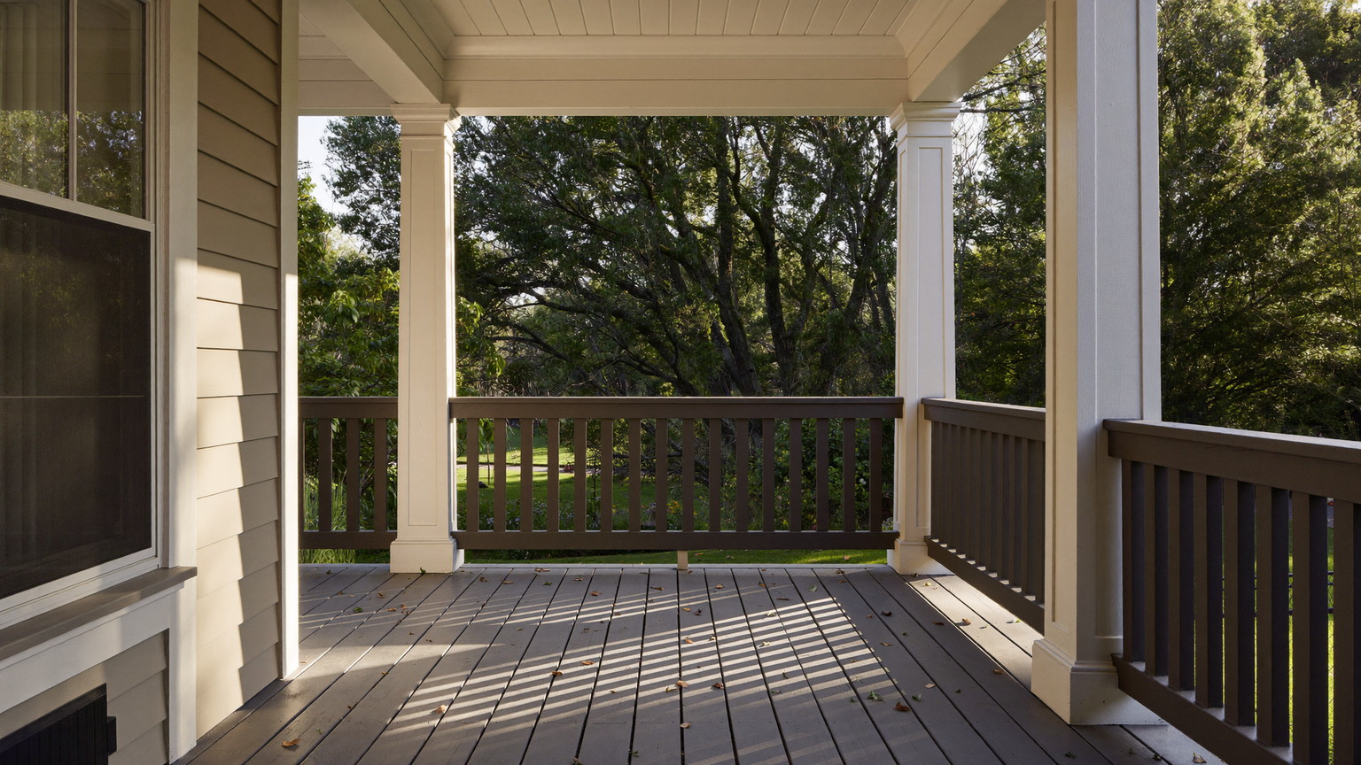 Editorial photograph of a compact painted wood porch on an older Brookline Massachusetts home: fir floor painted warm grey