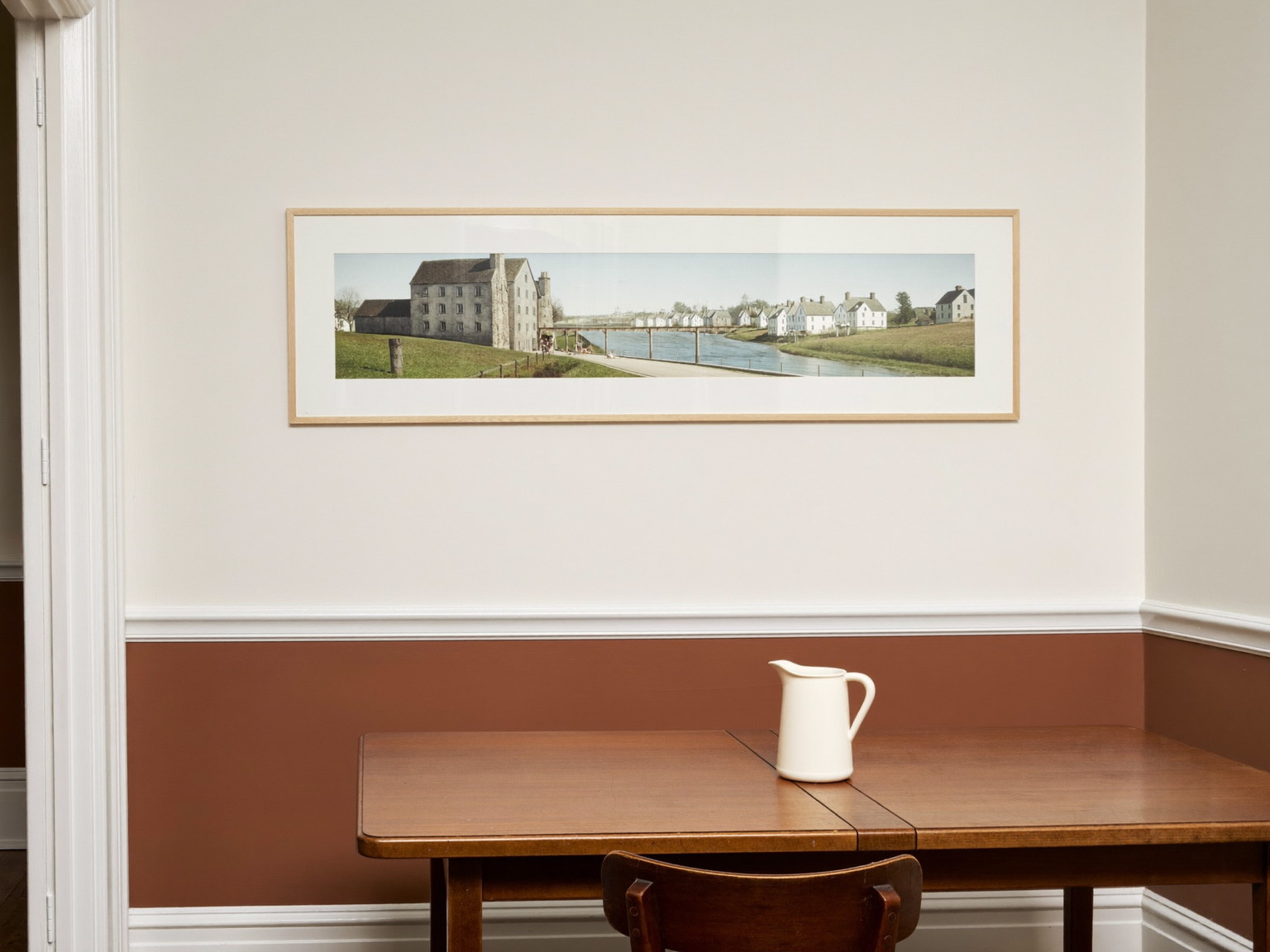 A repainted dining room in an older Cambridge home: warm white walls above a picture rail, deeper putty tone below, glossy white detailed trim, refinished