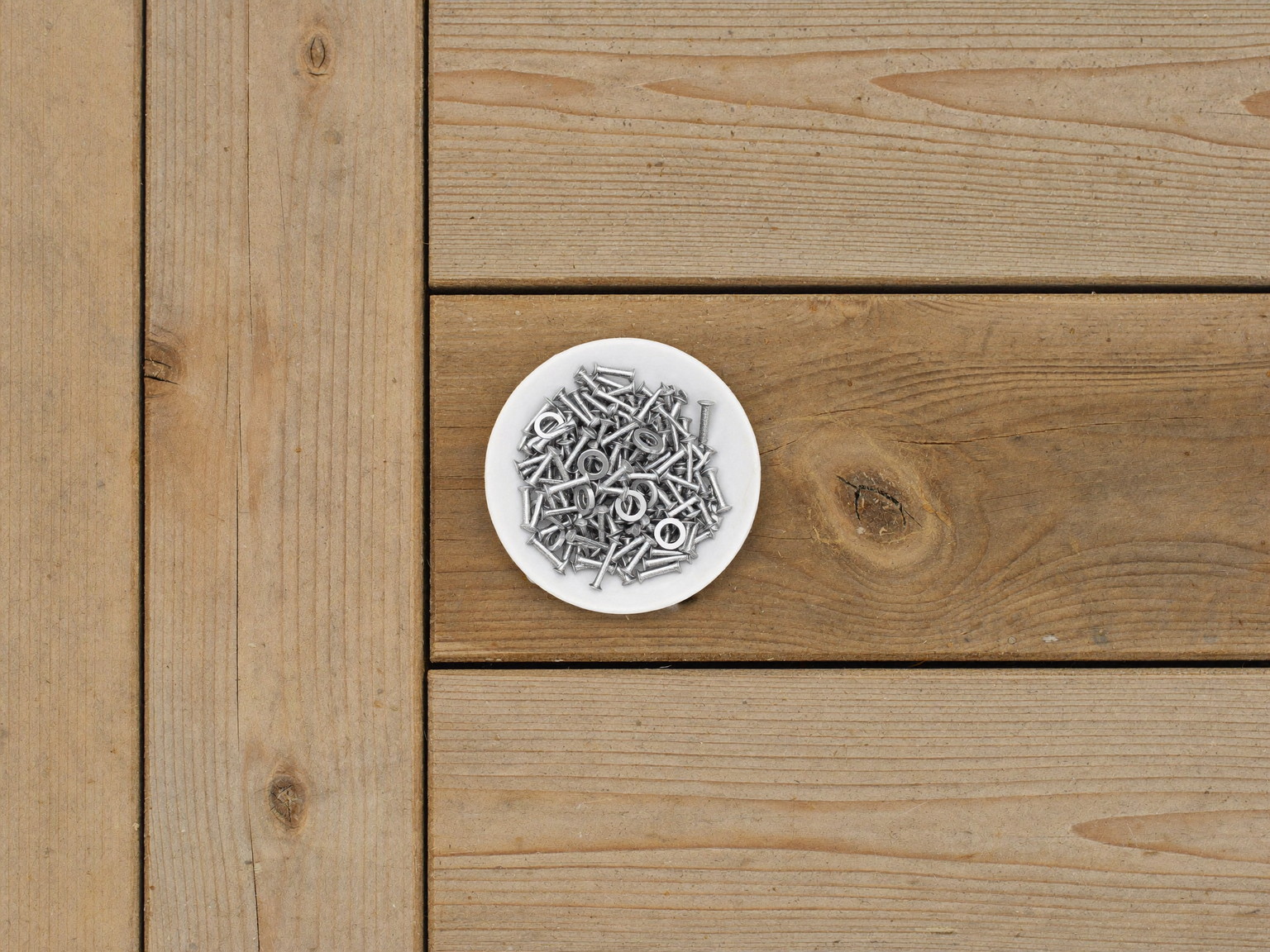 Overhead view of fresh pressure-treated decking boards with visible natural wood grain laid side by side