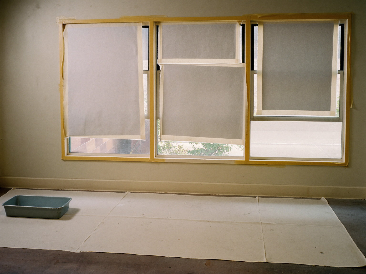 Prep day in an established Framingham parlor, tidy and completely unoccupied: a large canvas drop cloth protecting the floor, windows masked for painting