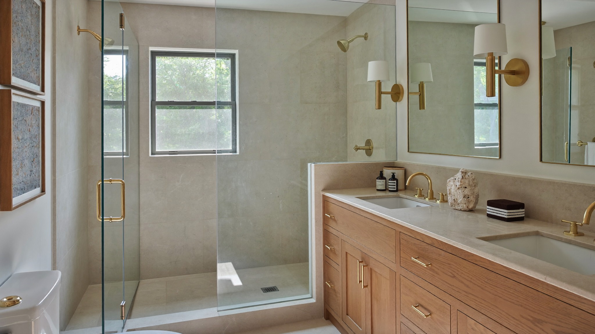 Freestanding tub and unlacquered brass filler against a plaster-pink limewash wall in a New England bathroom