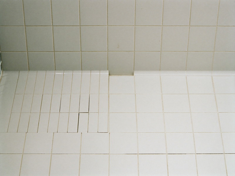 Tile repair blended into an existing floor with fresh grout — illustrative imagery