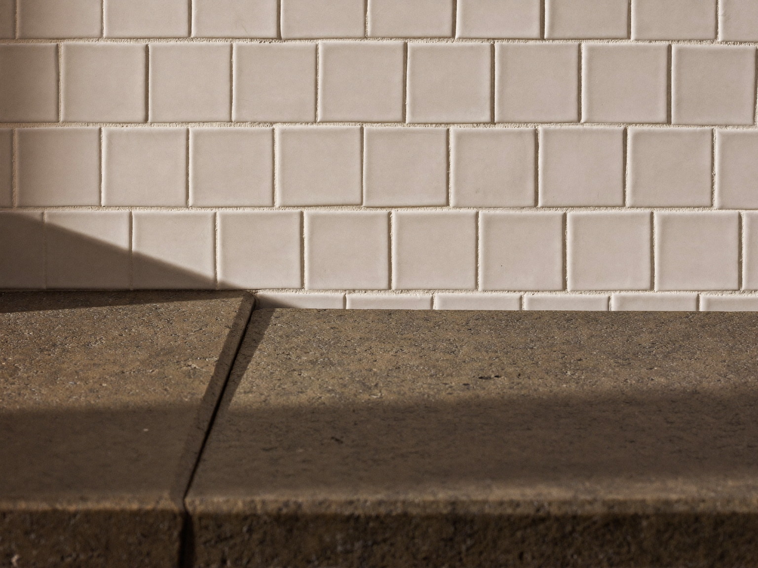 Honed soapstone counter meeting handmade white subway tile