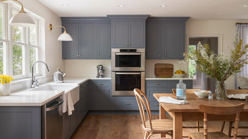 Renovated New England kitchen with slate-blue painted cabinetry and warm wood floors