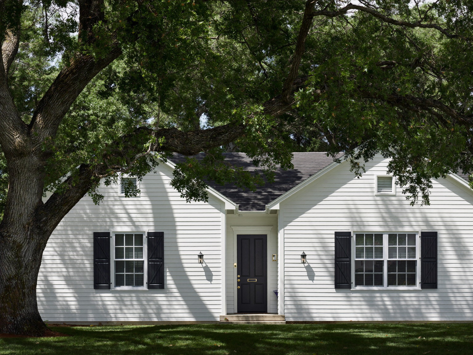 White New England farmhouse exterior with black shutters — illustrative painting imagery