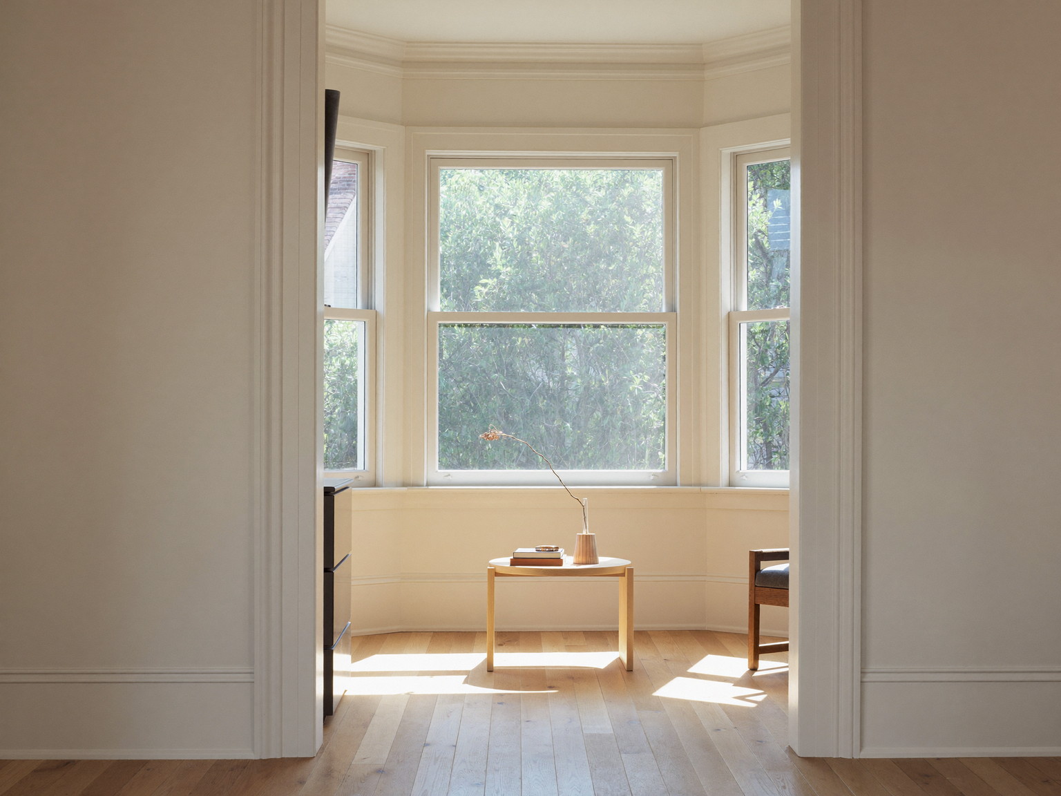 Finished living room with fresh warm white walls and crisp trim — illustrative painting imagery