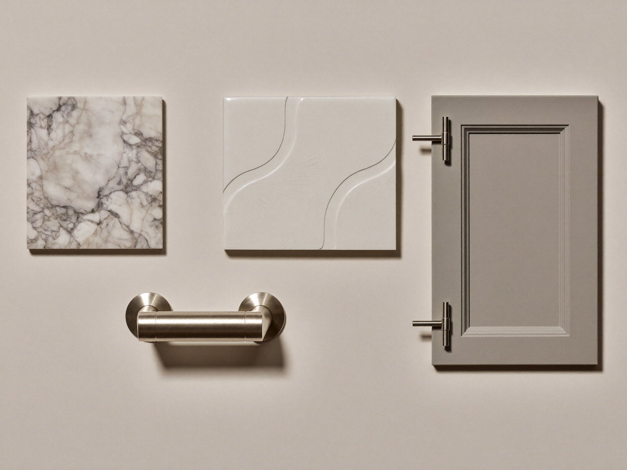 Still life photograph of bathroom material samples on a warm white table: white beveled tile pair, gray-veined marble square