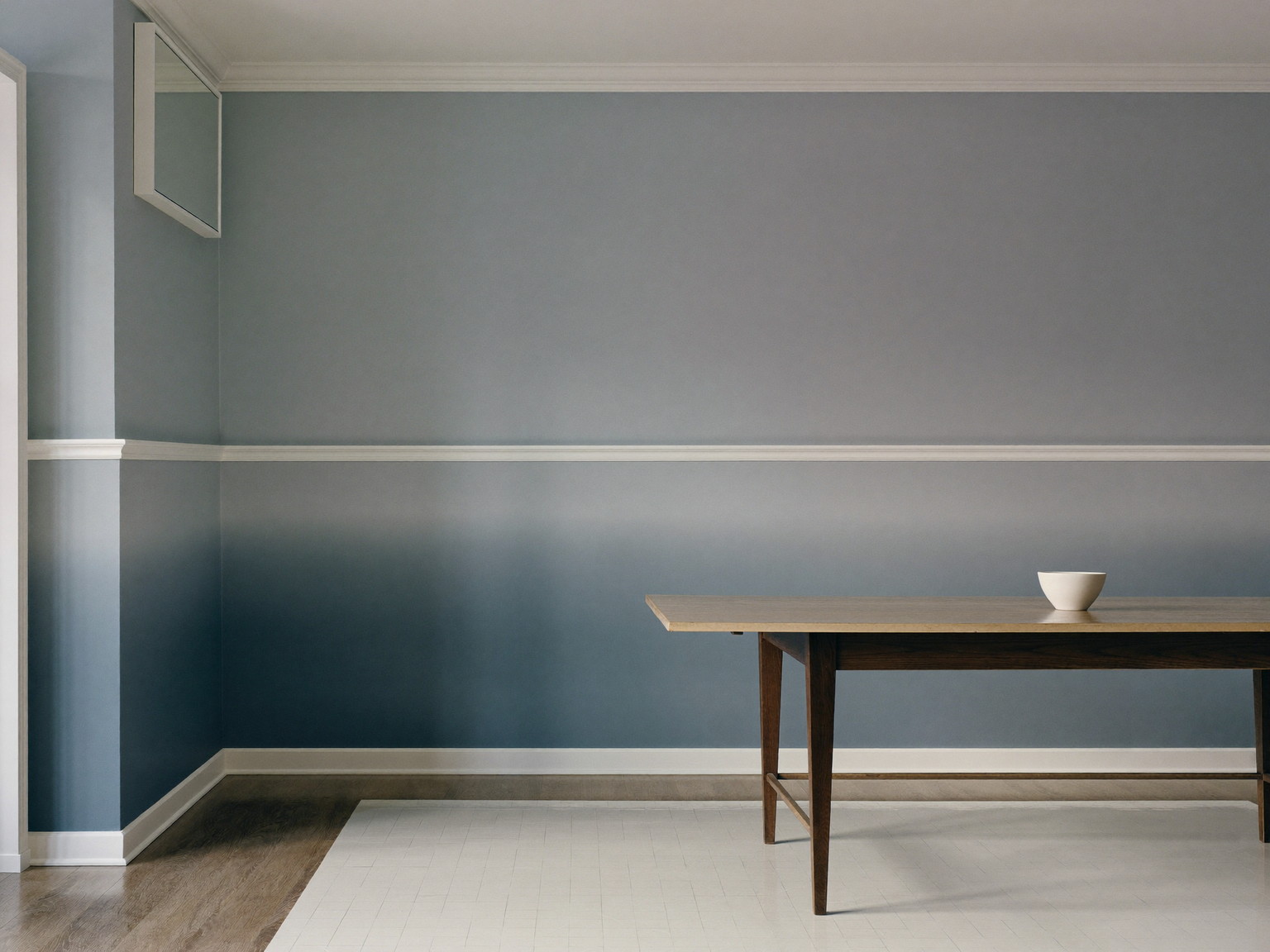 A repainted dining room in a comfortable Medway colonial: soft blue-gray walls above a chair rail, deeper slate below, glossy white trim and crown