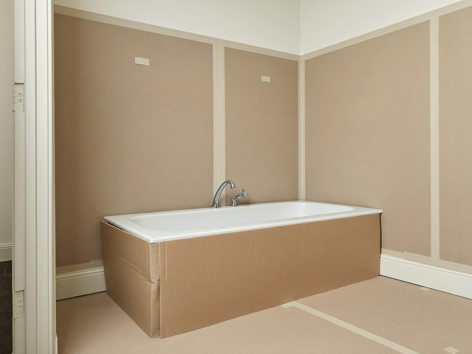 Mid-renovation bathroom in a well-kept Millis colonial, tidy and completely vacant: fresh cement backer board fitted on the walls with smooth taped seams,
