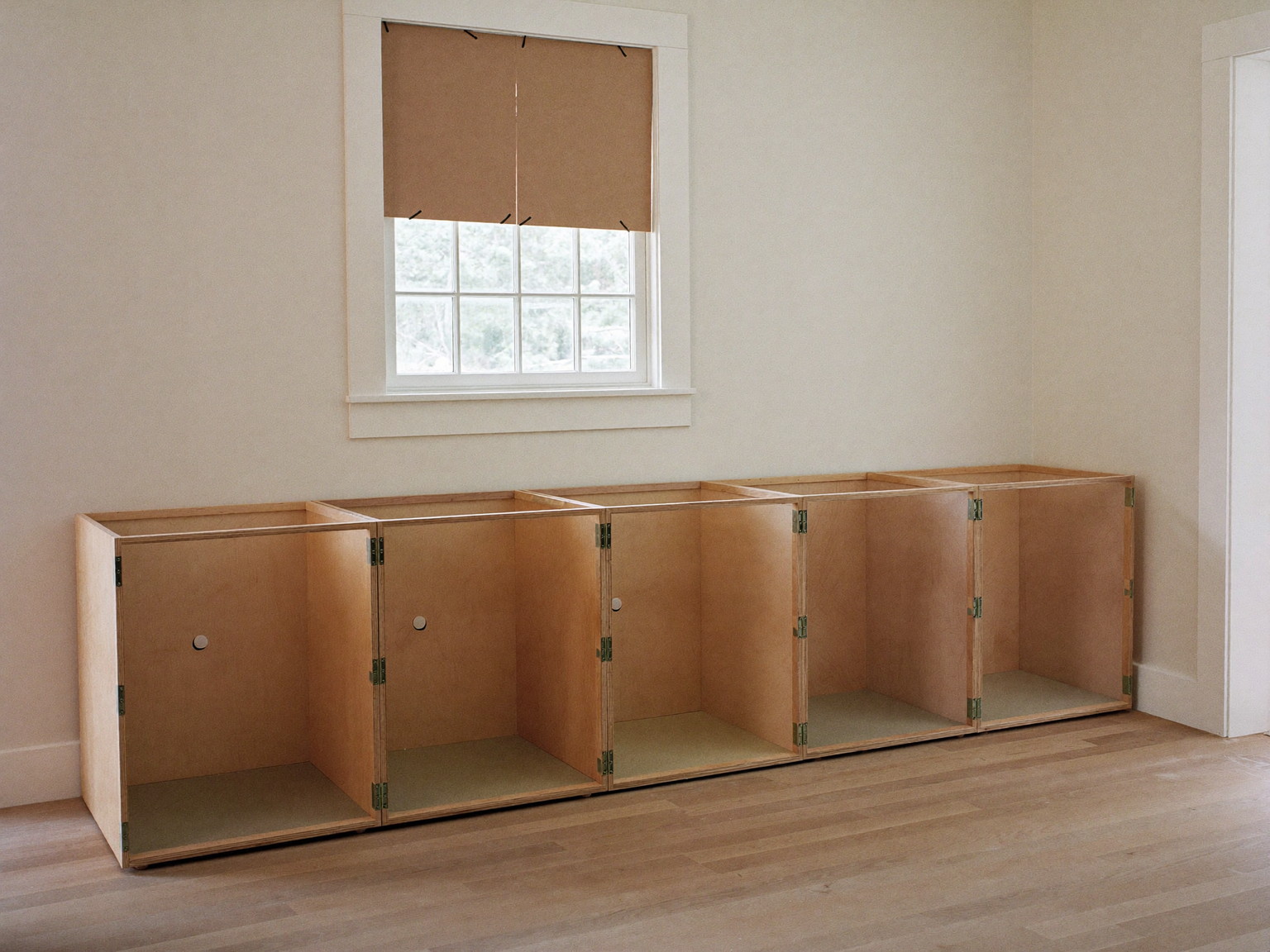 A tidy kitchen renovation in progress in a well-kept colonial, completely unoccupied: sturdy plywood cabinet boxes with solid sides installed in a row