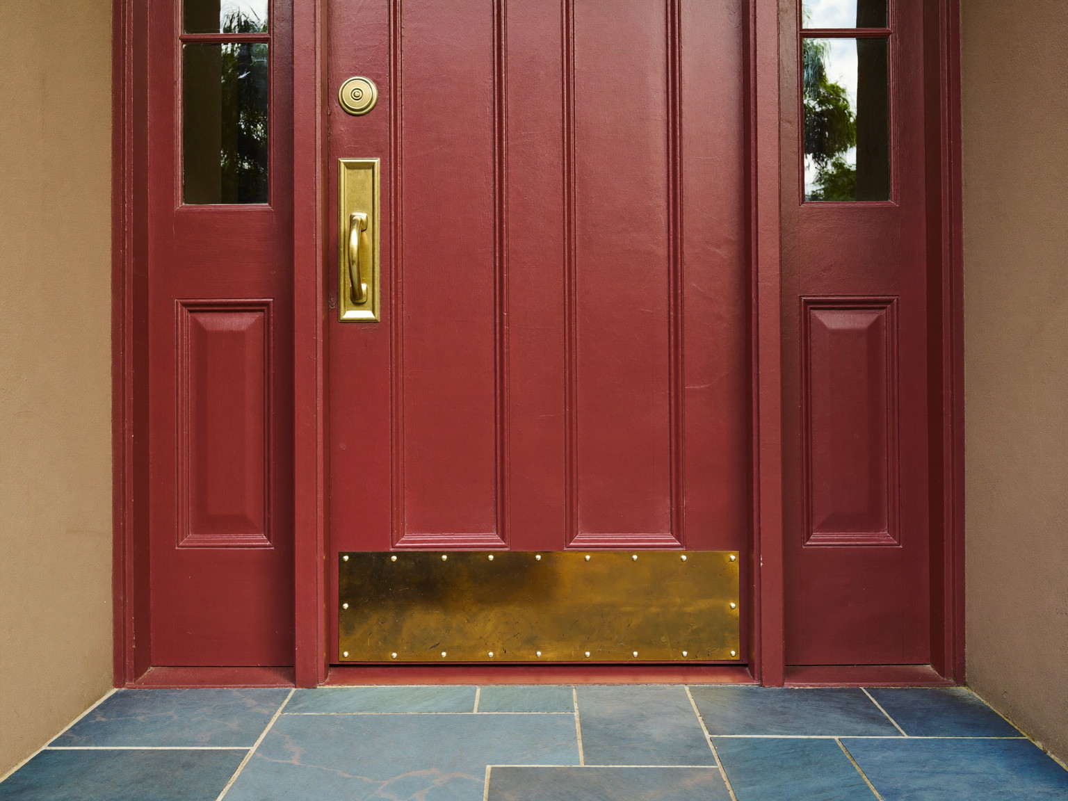 Cared-for New England entry with a repainted door and repaired casing
