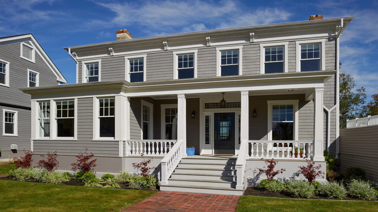 Well-kept New England colonial with crisp trim, sound siding, and a welcoming front porch