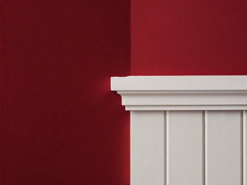 Crisp hand-cut paint line where a deep oxblood wall meets bright white trim