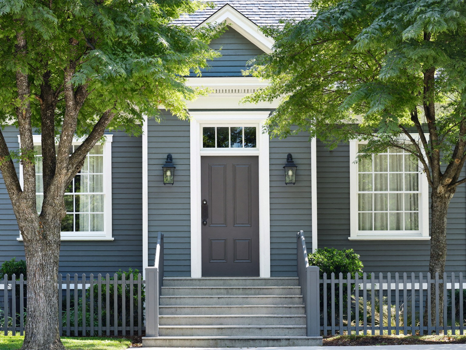 White clapboard exterior with black shutters after a complete repaint — illustrative imagery