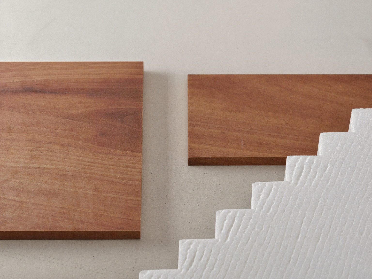 Material still life for a dry basement: vinyl plank samples, rigid insulation, and treated lumber