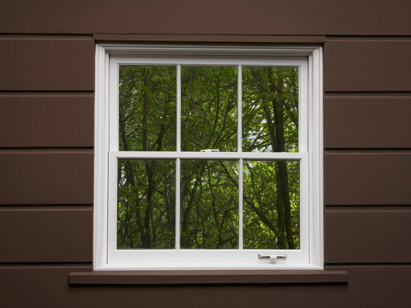 Restored double-hung window sash with fresh glazing and paint — illustrative repair imagery