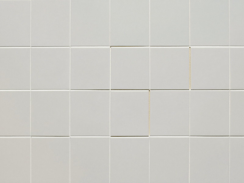 Bathroom floor tile repair finished flush with clean new grout lines — illustrative imagery