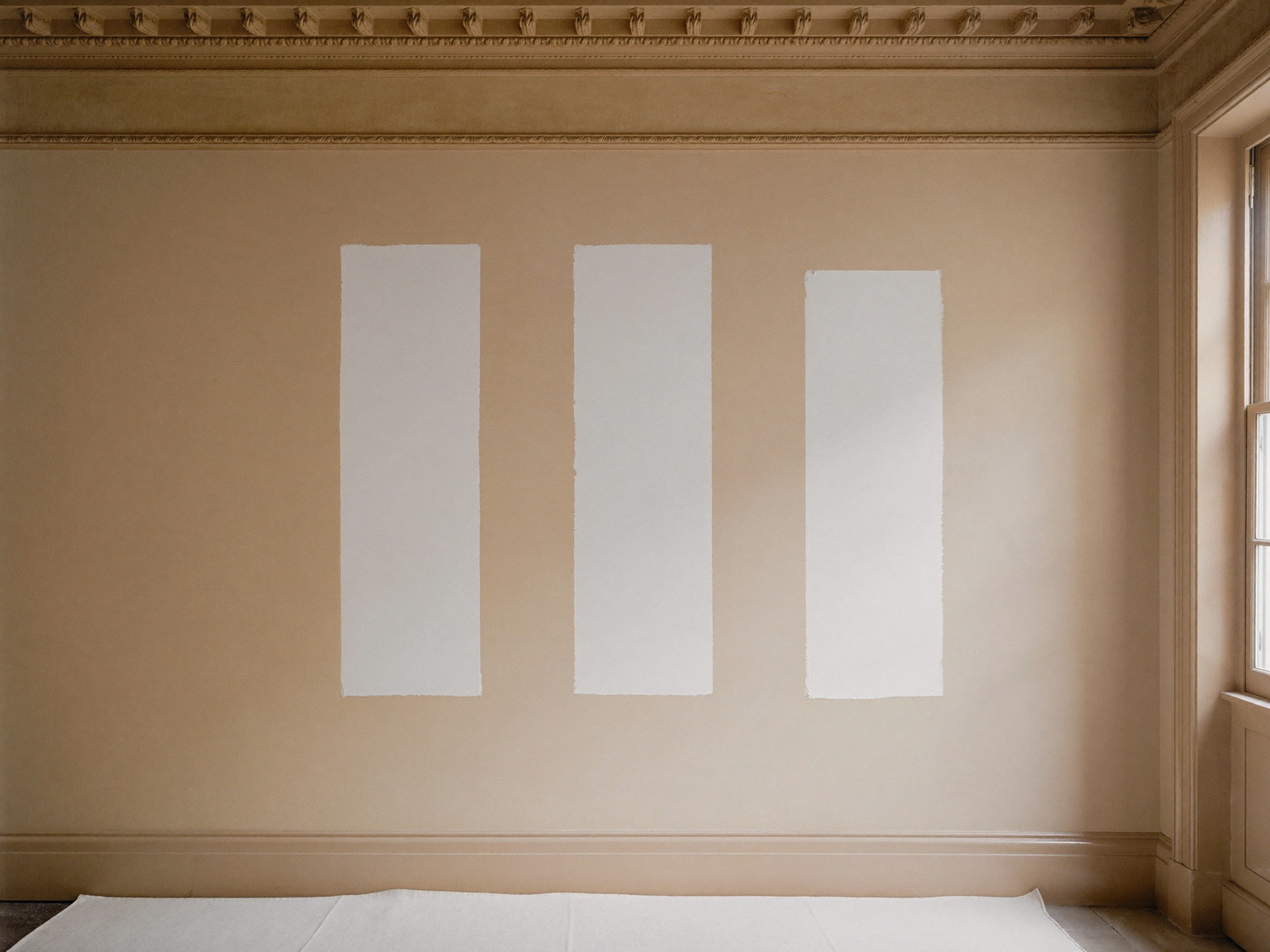 Older plaster wall mid-preparation with sanded joint-compound patches ready for primer
