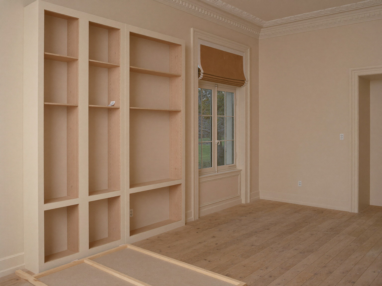An empty quiet kitchen renovation in progress in a classic colonial, completely unoccupied: unfinished inset cabinet frames standing fitted along one wall
